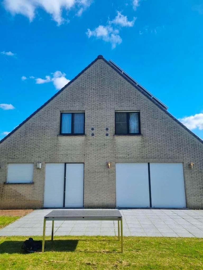 Démoussage de façade en brique avant nettoyage à Bruxelles